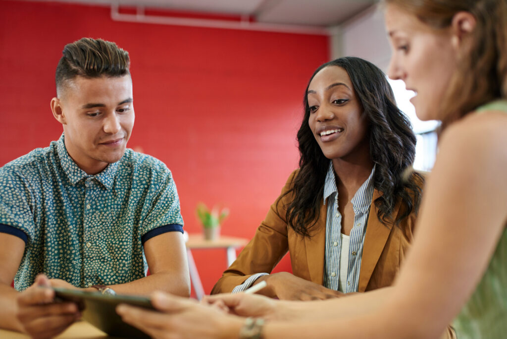 Interns collaborating with one another during a marketing internship.